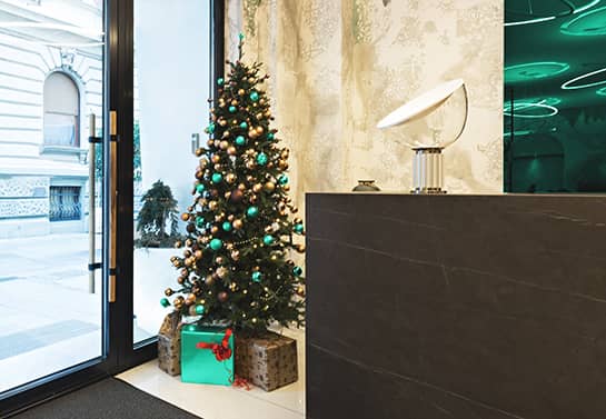office holiday decorating idea with Christmas tree near the door