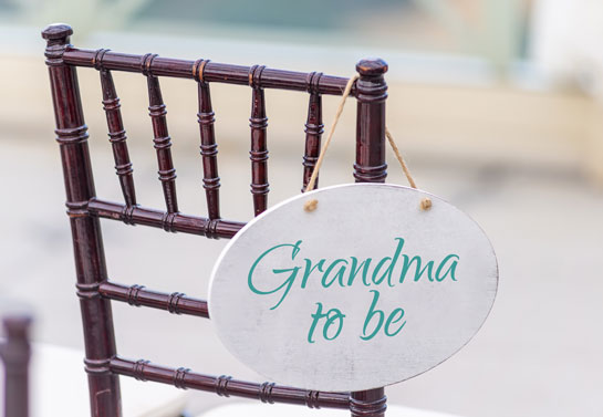 Outdoor baby shower Grandma-to-be decor hanging on chair