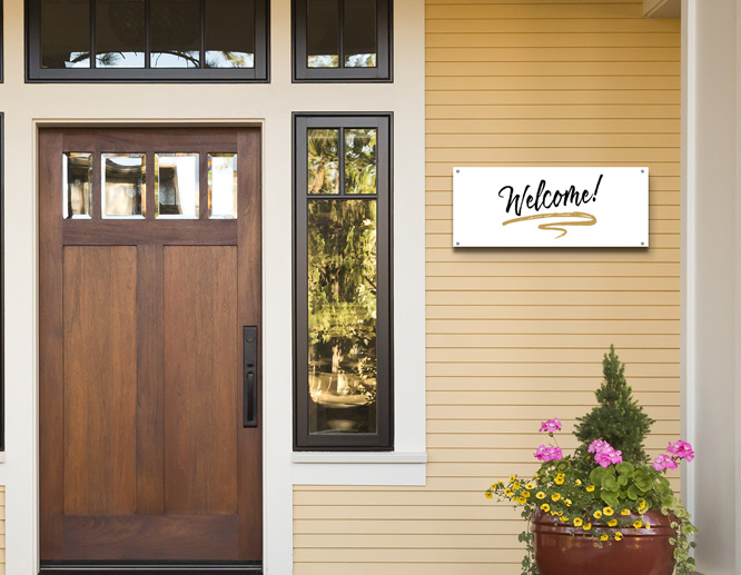 A front porch decorating idea with a white welcoming display