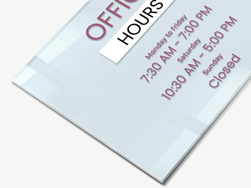 Clear acrylic sign for an office featuring business hours