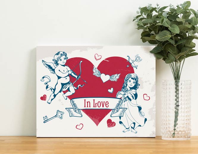 Valentine's Day decoration idea with two angels and a red heart picture set up on a table