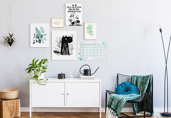office guest room idea for a gallery wall with artwork and a dry-erase board for notes