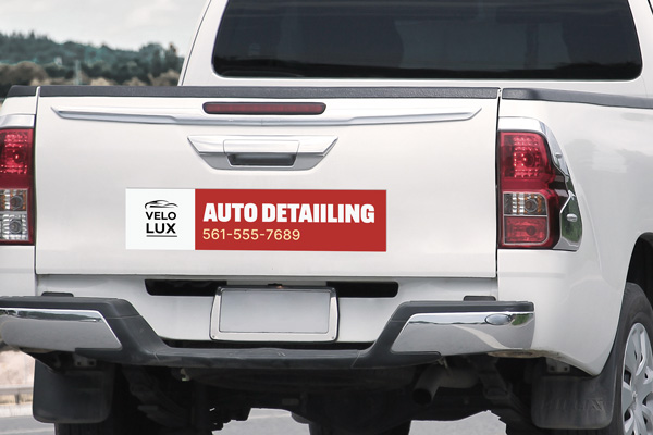 A red and white auto detailing business truck decal on the tailgate.