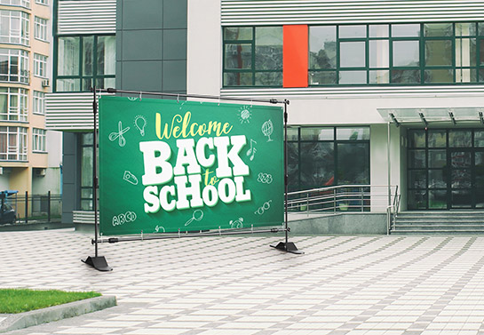 Simple back to school backdrop for an outdoor photoshoot placed in the school yard