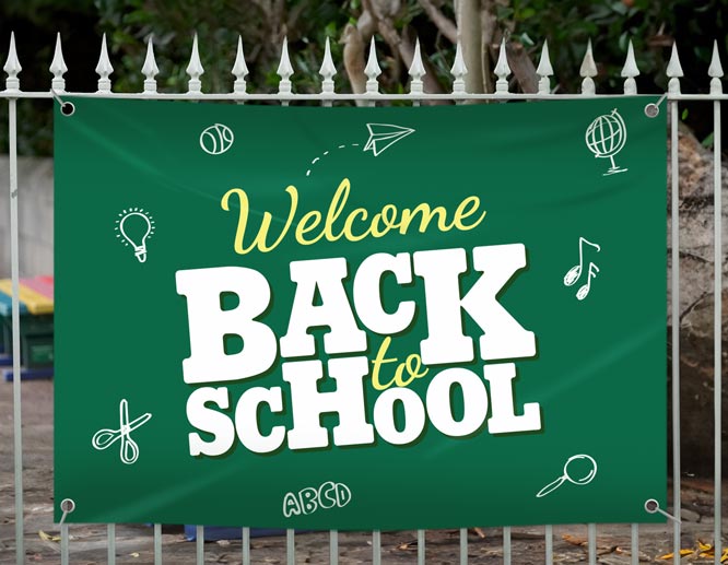 Green back to school vinyl banner displayed on the fence