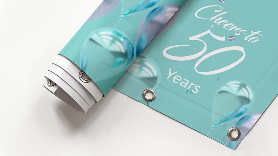 50th birthday banner with grommets displayed in a roll to showcase the product material