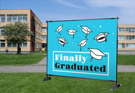 outdoor blue graduation banner idea with graduation caps print