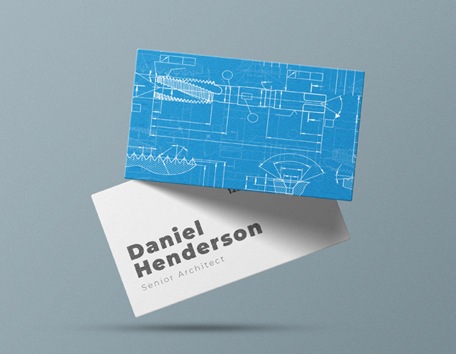 Blueprint-style business cards with technical line drawings and architectural graphics on blue and white cardstock.