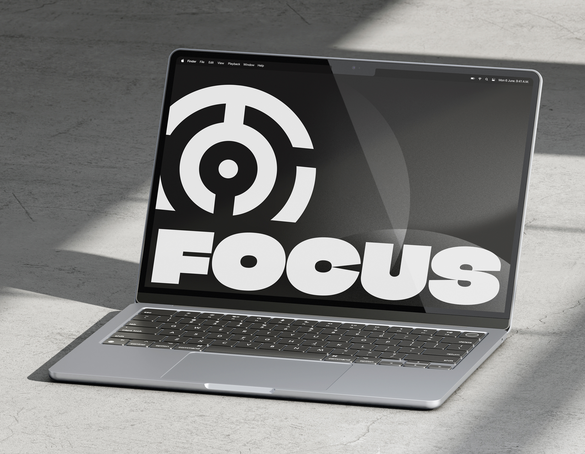 Laptop screen displaying bold white Focus text with circular target icon on dark background.