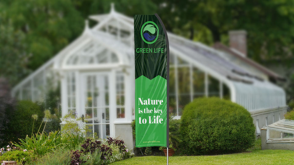 Green Life econo feather flag in green and black set up in the garden