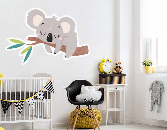 Outline cut nursery wall decal displaying a koala sleeping on a branch