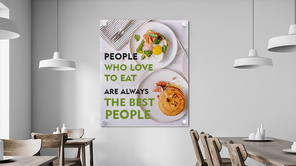 Large metal print of breakfast food in a restaurant featuring a quote in green and black