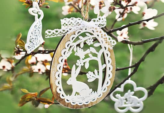 cute Easter decorations in white color hung from the tree