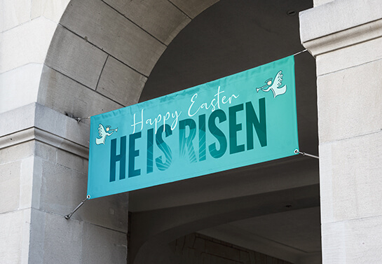 Easter church side wall decoration idea with a banner displaying the words Happy Easter