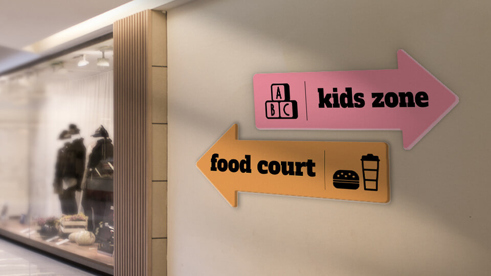 Arrow-shaped PVC signs displayed in a shopping mall