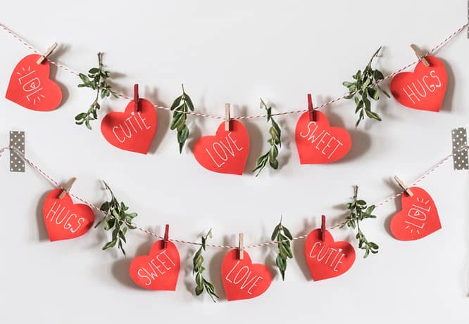 romantic decorating idea for Valentine's day with a DIY garland made of heart-shaped papers