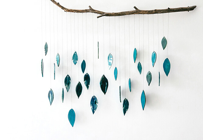 Easter decoration idea for home with feather garland hanging from a branch