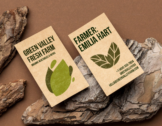 Eco-friendly business cards printed on recycled kraft paper with green leaf graphics and sustainable branding.