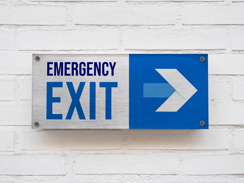 Brushed aluminum emergency exit sign with a blue and white arrow pointing left.