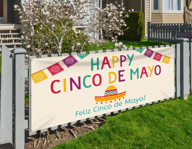 Outdoor happy Cinco de Mayo banner displaying a text fixed on the fence in front of the house