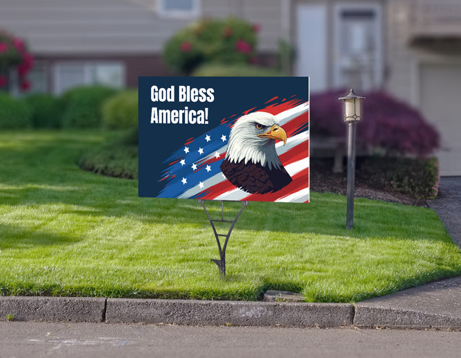 4th of July yard sign displaying the bald eagle, the US flag and a quote placed by the road