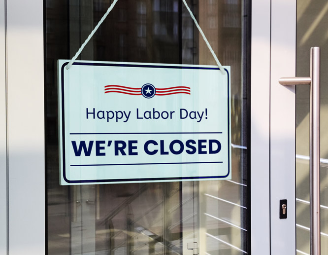 Celebratory Labor Day closed sign with a text hanging on the storefront door