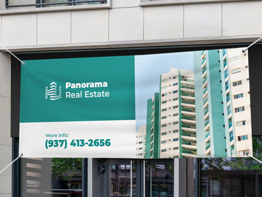 A vinyl banner reading Panorama Real Estate and hanging outdoors