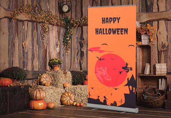 indoor Halloween party backdrop in orange displaying a witch house