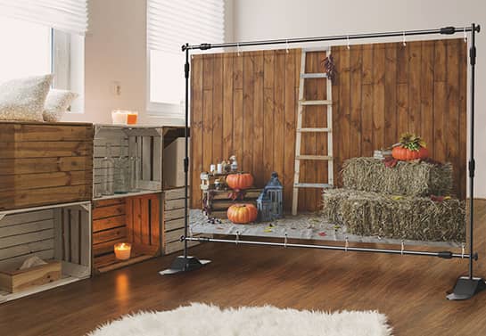 large harvest-themed Thanksgiving backdrop in a rustic room
