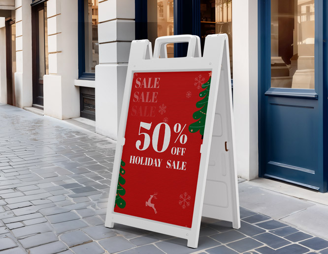 Holiday Sale sandwich board announcing 50% sale, installed at the entrance.
