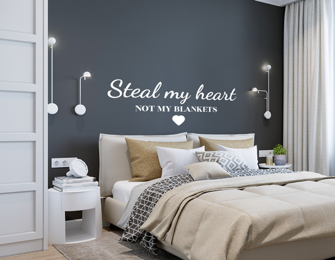 Fun bedroom wall saying decor in white over a black wall above the bed
