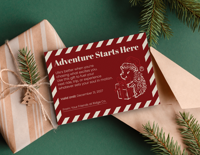 Red adventure gift card with candy cane border and treasure map illustration on pink paper.