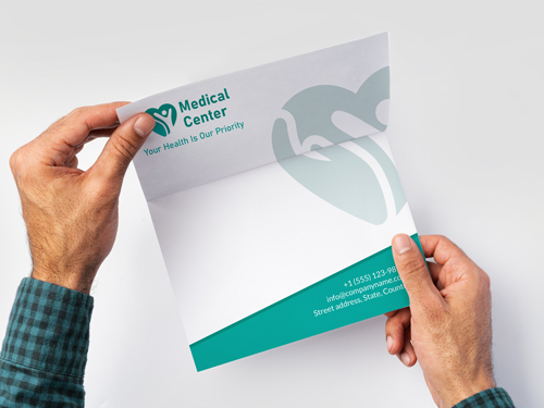 Letterhead printing for a medical center featuring teal accents and a heart logo for healthcare branding