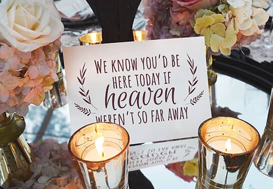 memorial table wedding sign idea with a quote surrounded with candles”=