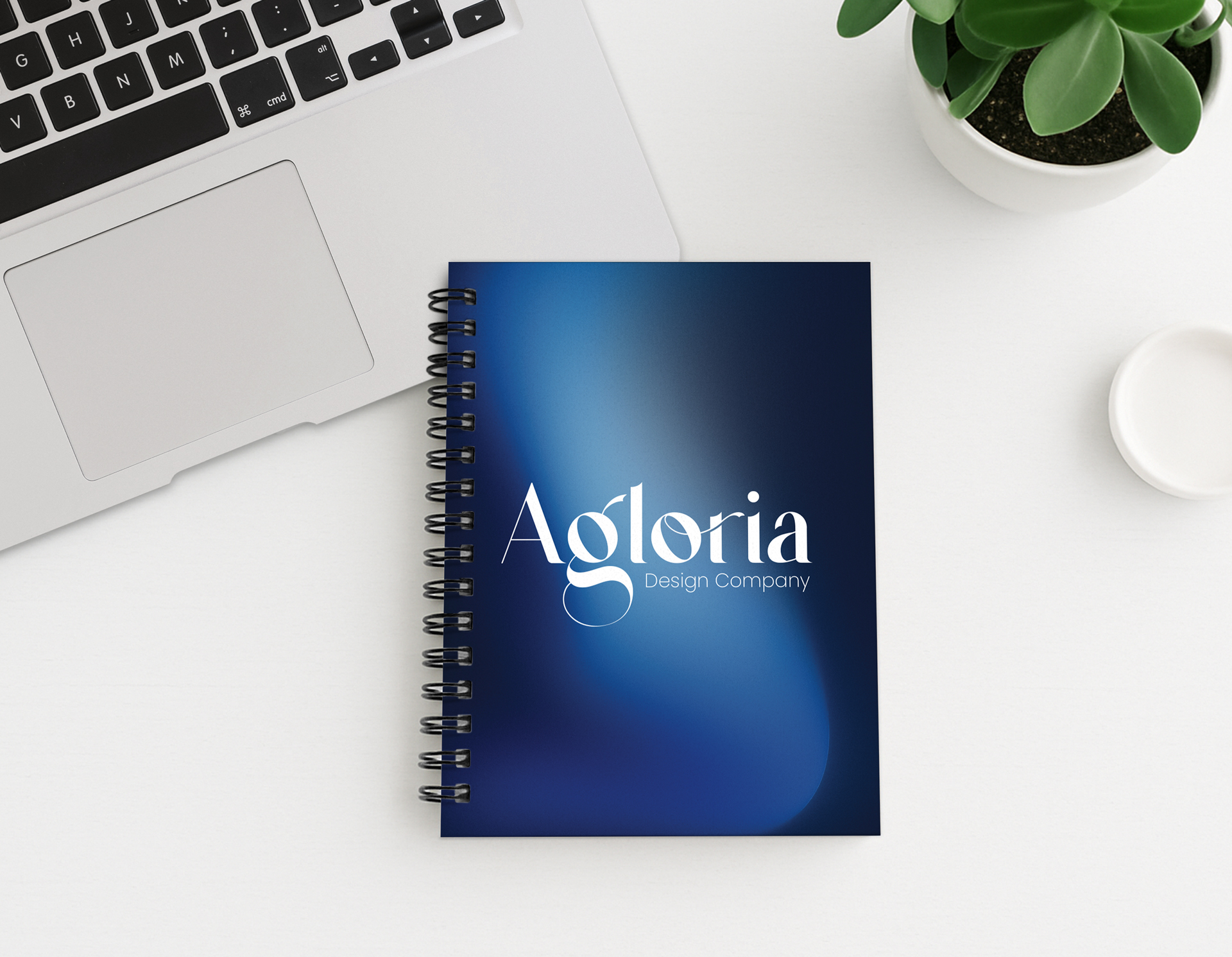 Spiral notebook with dark blue gradient cover displaying 'Agloria' text and preview icon