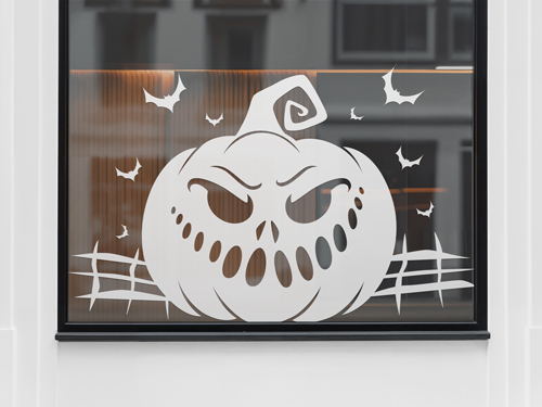 A white Halloween-themed window decal with a mischievous pumpkin face and flying bats. 
