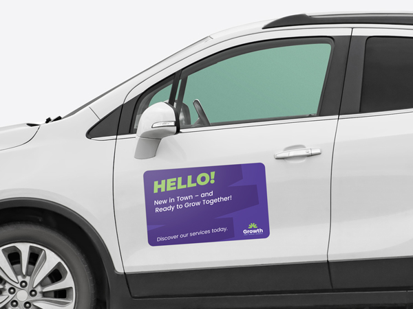 A car magnet attached to the front drivers door of a crossover promoting a newly established company.