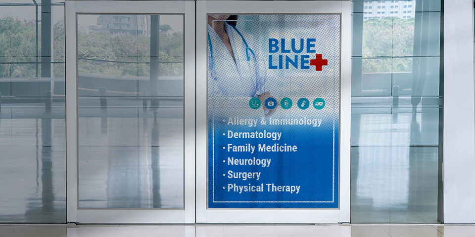 Informative perforated window graphics for healthcare facility featuring logo and services