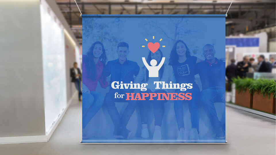 Fabric banner for a photoshoot area featuring the text 'Giving Things for HAPPINESS'