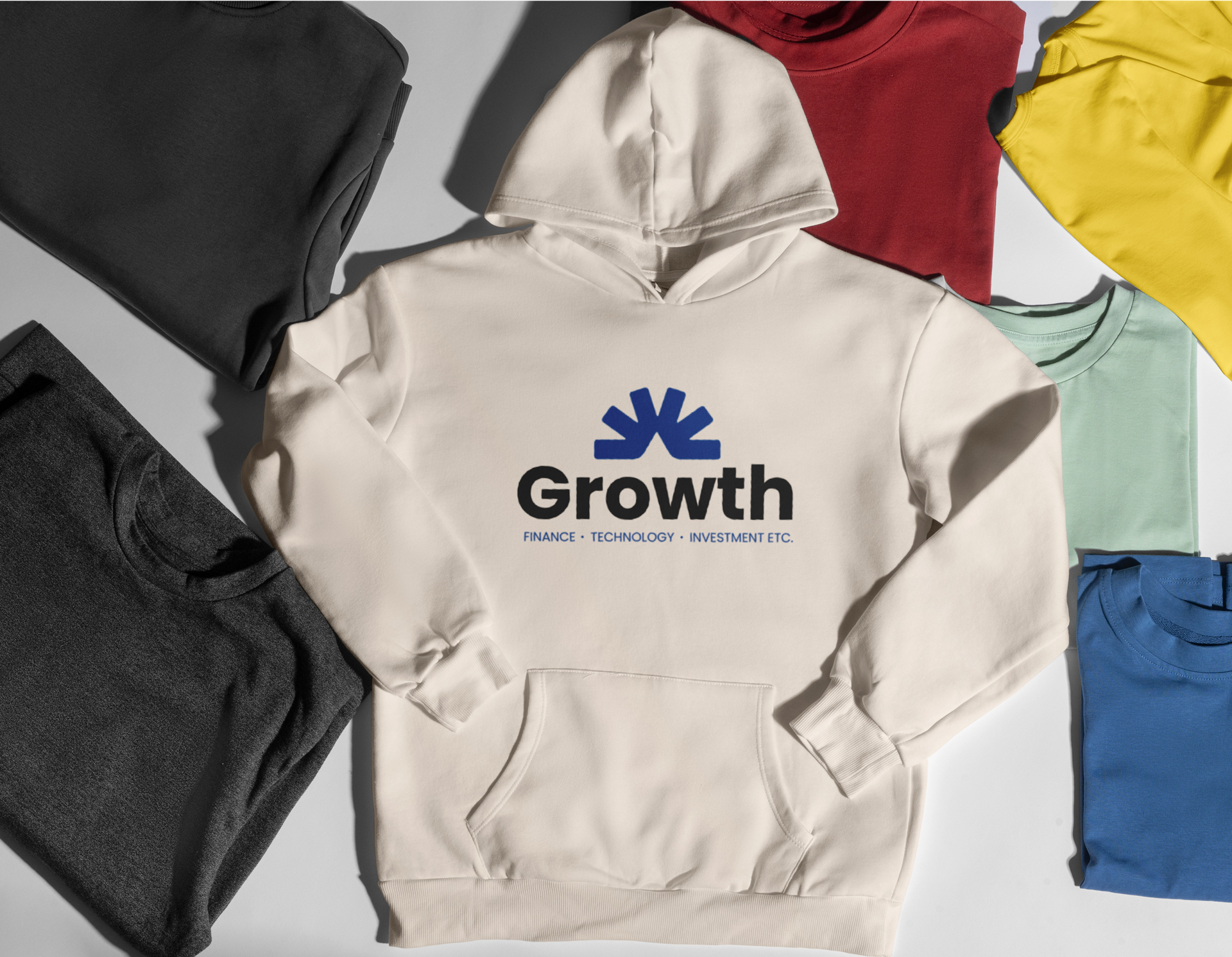 Youngsters' hoody with printing reading Growth, surrounded by colorful pieces of clothes.