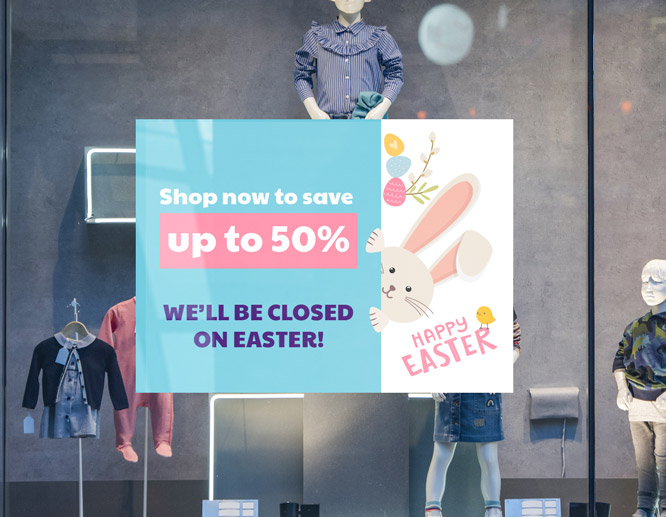 Printable closed for Easter sign showing up to 50% sale for the holiday on the storefront glass