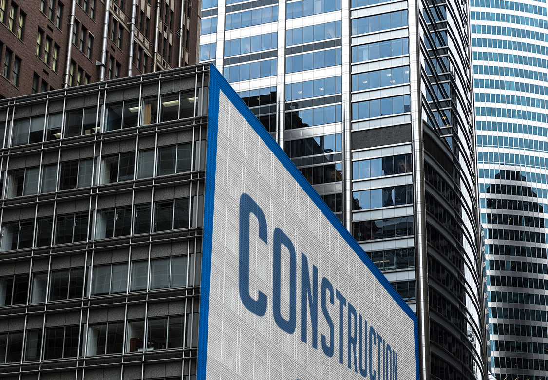 example of a mesh banner printed in large format with the word Construction fixed to a building wall