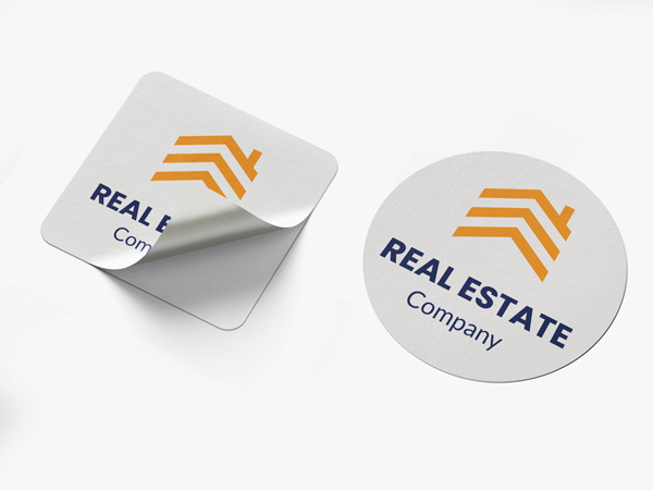 Square and circle die cut stickers featuring the brand logo for a real estate company.