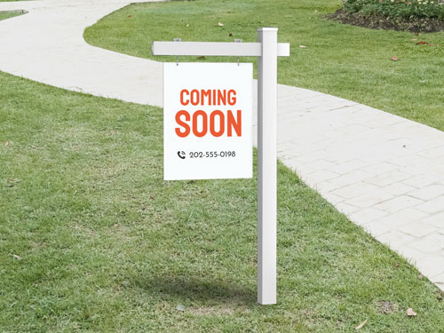 Anticipatory real estate sign in white, building excitement for a new listing`