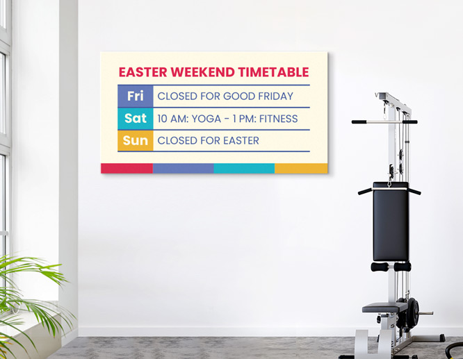 A colorful closed for Easter weekend sign mounted on a wall inside the gym