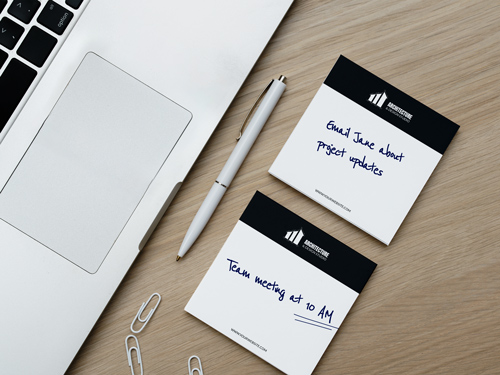 Post-it notes in black and white with handwritten reminders, showcasing an organized schedule