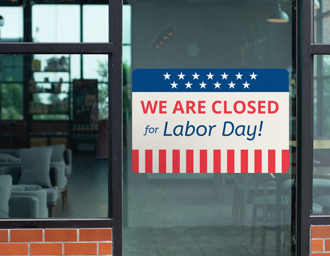 Restaurant closed for Labor Day sign with stars, stripes and a text applied to the window