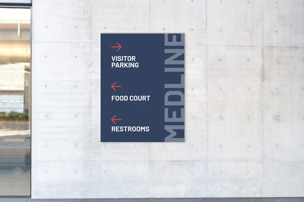 Wayfinding plastic signs pointing to visitor parking, food court, and restrooms.