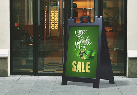 St. Patrick’s Day sale sign in green placed in a storefront area