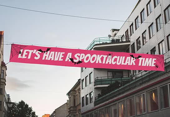 pink Halloween party banner in a big size hung in the street